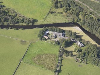 Oblique aerial view of Drumelzier Castle, taken from the SE.