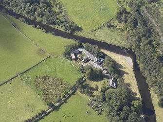 Oblique aerial view of Drumelzier Castle, taken from the NE.