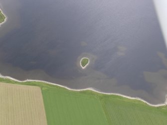 Oblique aerial view of Holm of Groundwater and Loch of Kirbister, looking SW.