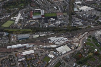 General oblique aerial view of the station and Tynecastle Park Stadium, looking SSE.