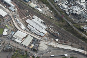 Oblique aerial view of Haymarket Motive Depot with new Edinburgh Tramway adjacent, looking to the SE.
