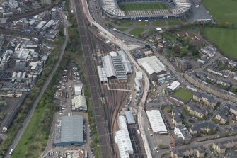Oblique aerial view of Haymarket Motive Depot with new Edinburgh Tramway adjacent, looking to the W.