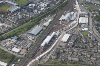 Oblique aerial view of Haymarket Motive Depot with new Edinburgh Tramway adjacent, looking to the NNE.