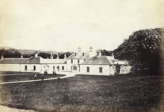 View of front exterior of Colonsay House with various figures in foreground, Colonsay.
Titled: '19. Kiloran House, Colonsay.'
PHOTOGRAPH ALBUM NO 186: J B MACKENZIE ALBUMS vol.1