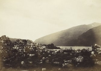 View, wide-angle, of the ruins of old Inishail Parish Church, including Loch Awe in the background, Lorn, Argyll. 
Titled: '2. Inishail'.
PHOTOGRAPH ALBUM No. 187, (cf PAs 186 and 188) Rev. J.B. MacKenzie of Colonsay Albums,1870, vol.2.

