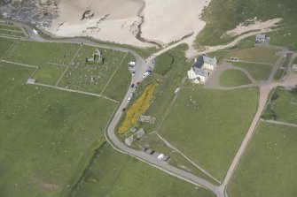 Oblique aerial view of Balnakeil House, Balnakeil Parish Church and Churchyard, looking to the N.