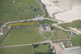 Oblique aerial view of Balnakeil House, Balnakeil Parish Church and Churchyard, looking to the WNW.