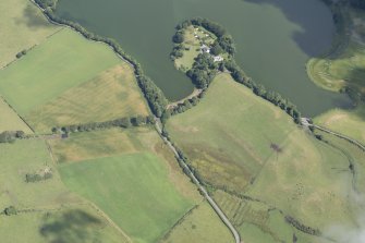 Oblique aerial view of Greenloch House, the site of Soulseat Abbey and the cropmarks of the ring ditch, looking NE.