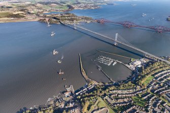General oblique aerial view of the River Forth showing the construction site of the new Queensferry Crossing, the Forth Road and Rail bridges and Port Edgar looking to the NE.
