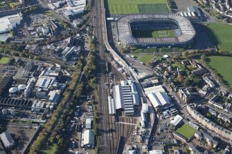 Oblique aerial view of the Edinburgh Tramway, Murrayfield Stadium and Haymarket Motive Power Depot, looking to the W.