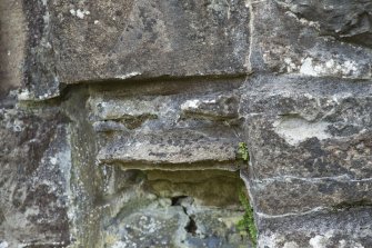 Detail of east weathered corbel to middle order of door archway.