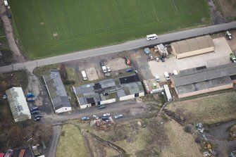 Oblique aerial view of the First World War airfield buildings, looking E.