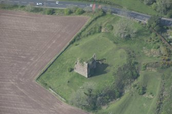 Oblique aerial view of Torthorwald Castle, looking NW.