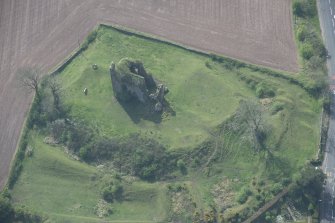 Oblique aerial view of Torthorwald Castle, looking SW.