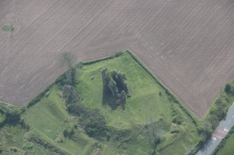 Oblique aerial view of Torthorwald Castle, looking SSW.