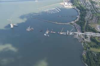 Oblique aerial view of the construction of the Queensferry Crossing and Port Edgar, looking ESE.