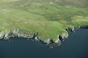 General oblique aerial view of Houbie Broch, Fetlar, looking N.