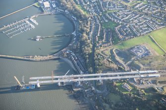 Oblique aerial view of the construction works for the approach to the Queensferry Crossing on the S bank with Port Edgar beyond, looking ESE.