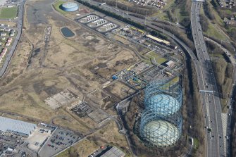 Oblique aerial view of Provan Gasworks including gasholders, looking ENE.