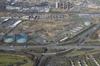 Oblique aerial view of Provan Gasworks including gasholders, looking NNW.