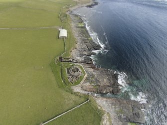 Oblique aerial view of Mid Howe broch, looking SE.