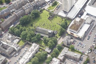 Oblique aerial view of Trinity House and South Leith Parish Church and Churchyard, looking SSE.