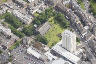 Oblique aerial view of Trinity House and South Leith Parish Church and Churchyard, looking NE.