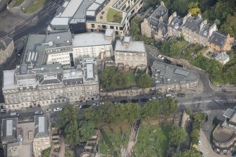Oblique aerial view of 23 - 29 Waterloo Place, Waterloo Place and Old Calton Burial Ground, looking N.