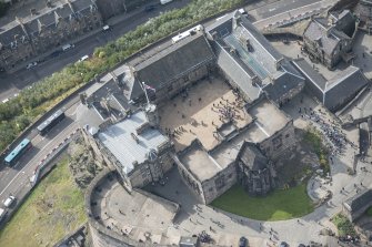 Oblique aerial view of Edinburgh Castle centred on the Palace Yard, looking SW.