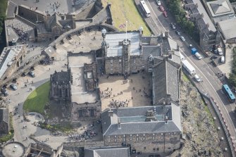 Oblique aerial view of Edinburgh Castle centred on the Palace Yard,  looking E.