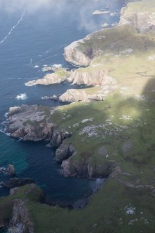 Oblique aerial view of the coast at Mangersta with Stac Dhomhnaill Chaim in the middle distance, looking NW.