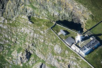 Oblique aerial view of Barra Head Lighthouse and the possible dun, looking NW.