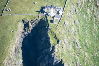 Oblique aerial view of Barra Head Lighthouse and the possible dun, looking E.