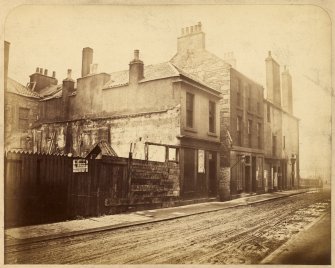View of houses at junction between North College Street and Hastie's Close, Edinburgh, prior to demolition.
