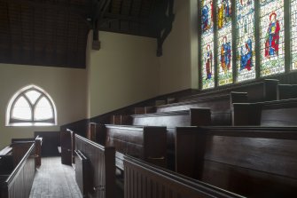 East gallery. View of pews.