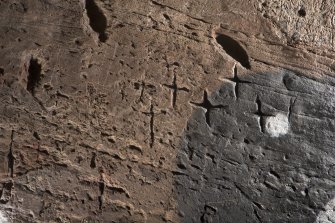 Detail of incised crosses on wall at north side of entrance