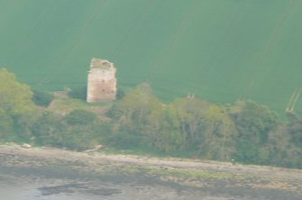 An oblique close aerial view of Castle Craig and S shore of the Cromarty Firth, looking N.