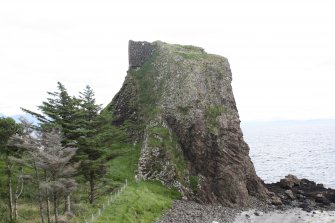 Historic Building Survey photograph, From W, Castle on side of stack, Coroghon Castle, Canna