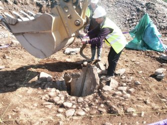 Archaeological excavation, Lifting out broken capstone, Holm Mains Farm, Inverness, Highland