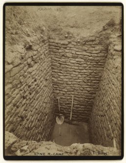 Excavation photograph of stone-lined pit in Lyne Roman Camp,