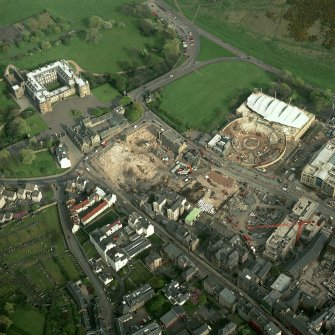 Oblique aerial view of Edinburgh centred on the construction of the Scottish Parliament with the 'Our Dynamic Earth' building and Holyrood Palace adjacent, taken from the WNW.