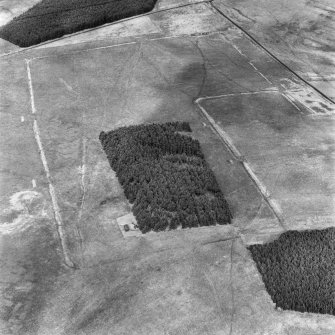 Pennymuir, oblique aerial view, taken from the SSW, centred on two Roman Temporary Camps and a linear earthwork. An area of rig and the course of 'Dere Street' are visible in the top right-hand corner of the photograph.