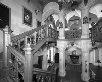 Interior view of arcade and oak staircase in entrance hall at Minard Castle from south.
