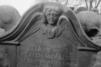 North Leith Burial Ground.
View of gravestone, James Home, large soul above part of inscription panel.