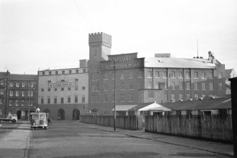 Glasgow, Scotstoun Mill Road, Scotstoun Mill
General view from WNW showing the three round-headed doorways of tram depot and NW front and part of SW front of mill
