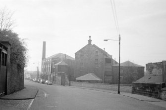 Glasgow, 206 Old Dumbarton Road, Bishop Mill
View from SE showing SE front of mill with Artizan Machine Tool Works in background and remains of warehouse in right foreground
