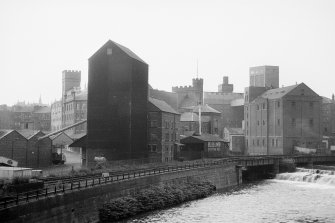 General view from W showing mills with railway bridge on right