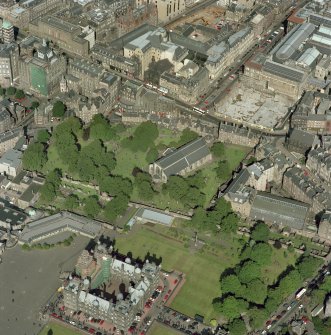 Scanned image of oblique aerial view, taken from the SSW, centred on Candlemaker Row, Greyfriars Church and burial-ground.