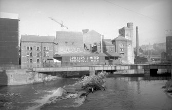 General view from SSW showing SSW front of bridge with mill in background