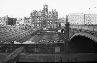 View from SSE showing W end of Waverly Station, with WSW front of North Bridge in foreground, North British Hotel in middle background and GPO building in right background